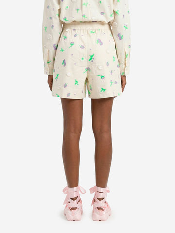 ESSENTIEL ANTWERP Pantaloncini bianchi con decorazioni floreali in paillettes, strass e perline viola e verdi Off white